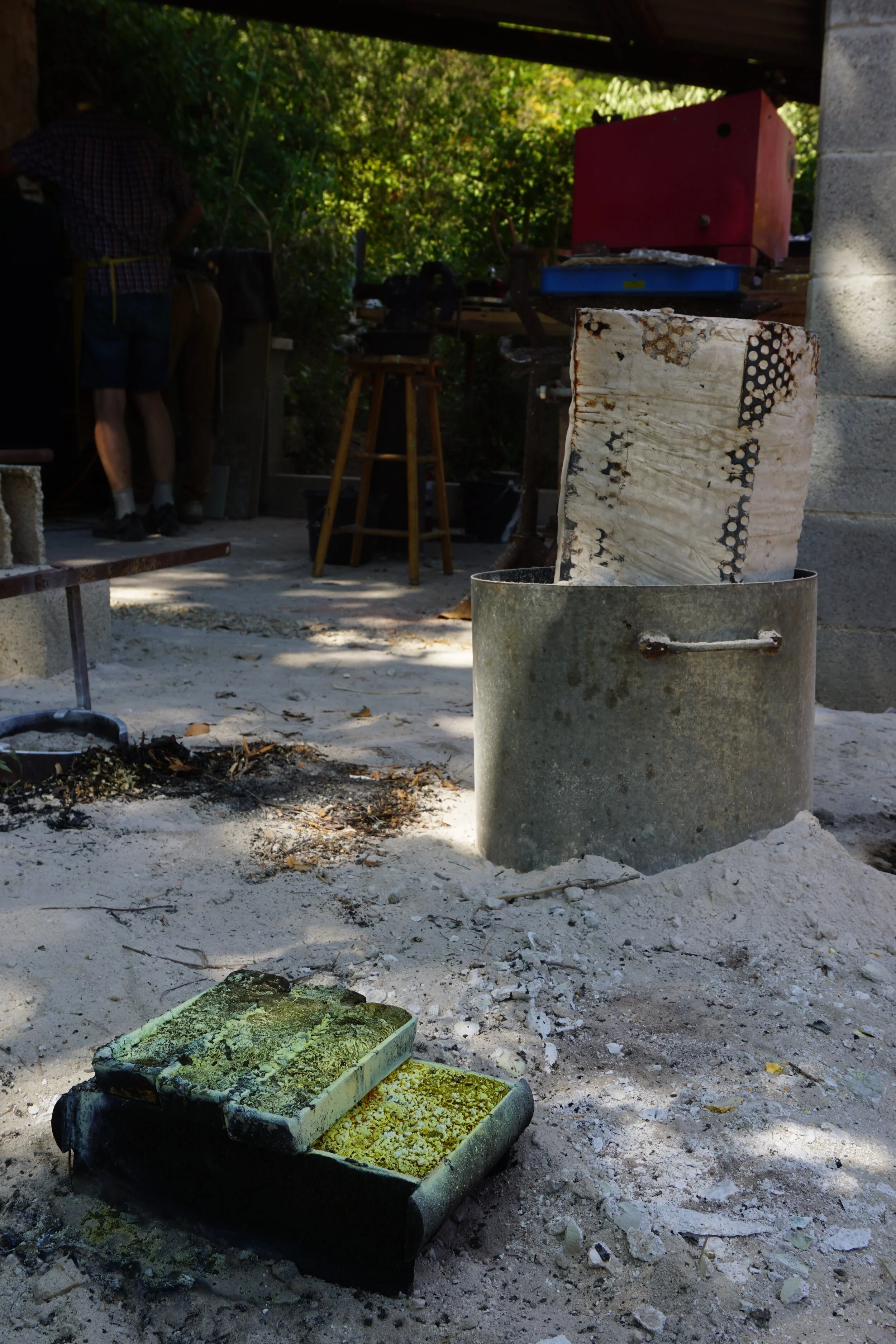 molten bronze bars of excess material poured